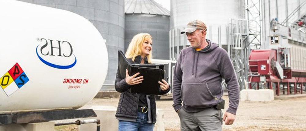 Certified Energy Specialist speaks with CHS propane customer on farm